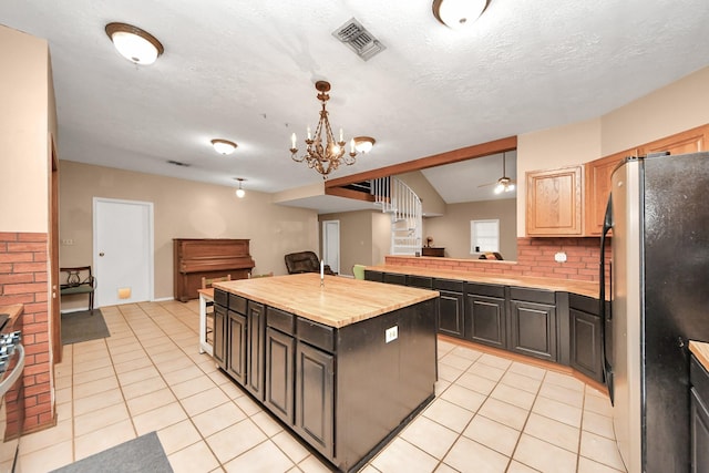 3810 Peters San Felipe Rd, Sealy, TX 77474 - kitchen with open floor plan, light tile patterned floors, visible vents, and freestanding refrigerator