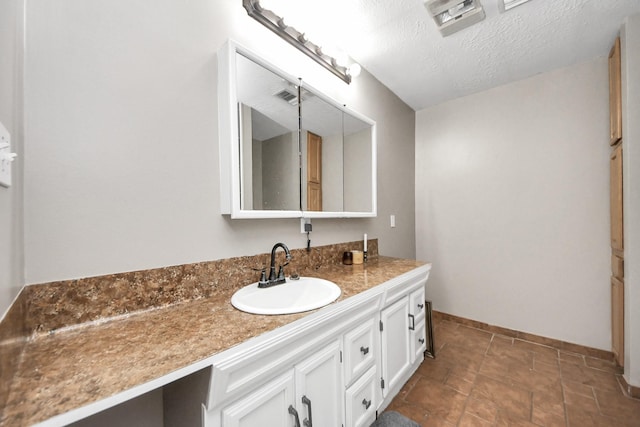3810 Peters San Felipe Rd, Sealy, TX 77474 - bathroom with vanity, baseboards, a textured ceiling, and visible vents