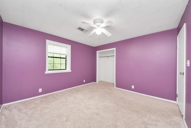 3810 Peters San Felipe Rd, Sealy, TX 77474 - unfurnished bedroom with a closet, baseboards, carpet floors, visible vents, and ceiling fan