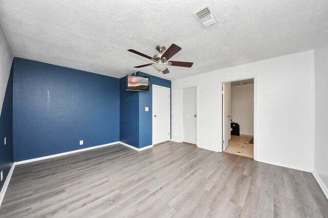 3810 Peters San Felipe Rd, Sealy, TX 77474 - unfurnished bedroom with visible vents, baseboards, wood finished floors, and a textured ceiling