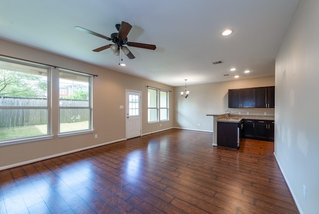 17035 Wilthorne Gardens Ct, Houston, TX 77084 - unfurnished living room featuring baseboards, a sink, dark wood-type flooring, and recessed lighting