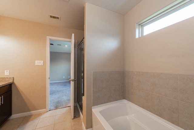 17035 Wilthorne Gardens Ct, Houston, TX 77084 - full bath featuring a shower stall, a garden tub, tile patterned floors, vanity, and visible vents