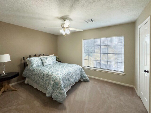 2202 Canterbury Ct, Deer Park, TX 77536 - bedroom featuring carpet floors, baseboards, a ceiling fan, and a textured ceiling