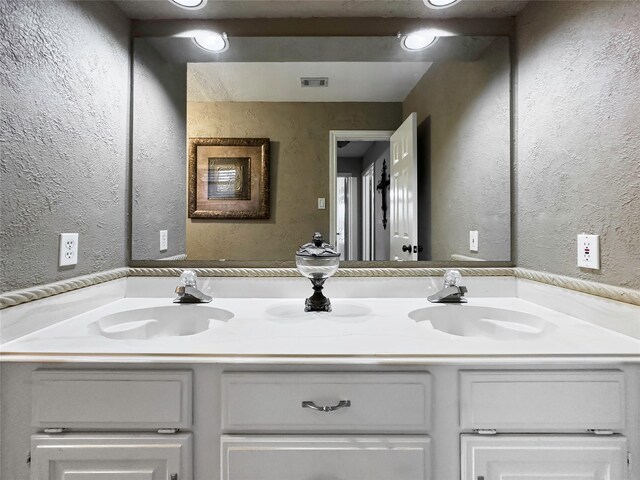 2202 Canterbury Ct, Deer Park, TX 77536 - bathroom featuring a textured wall and double vanity