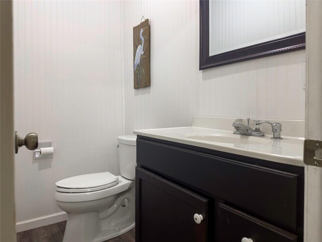 2202 Canterbury Ct, Deer Park, TX 77536 - half bath featuring vanity, toilet, wood finished floors, and baseboards