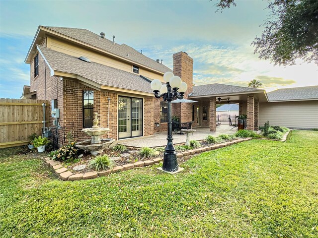 2202 Canterbury Ct, Deer Park, TX 77536 - rear view of property with a patio area, brick siding, a chimney, french doors, and a shingled roof