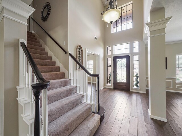 2202 Canterbury Ct, Deer Park, TX 77536 - entrance foyer featuring stairs, wood finished floors, a towering ceiling, ornate columns, and baseboards