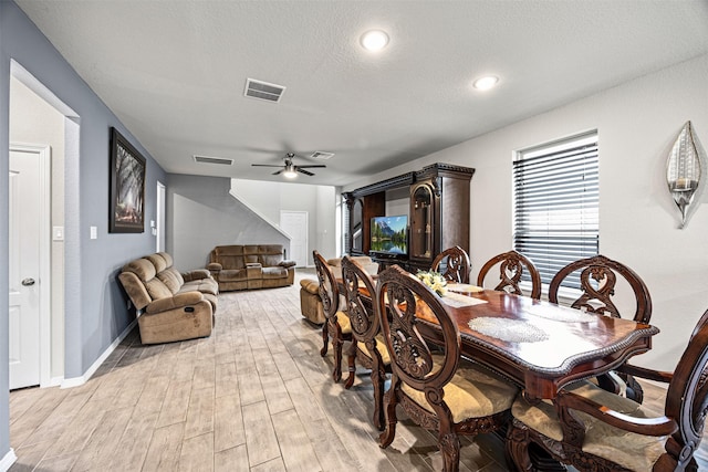 24818 Russet Bluff Trl, Houston, TX 77336 - dining area with a textured ceiling, light wood-style flooring, visible vents, and ceiling fan