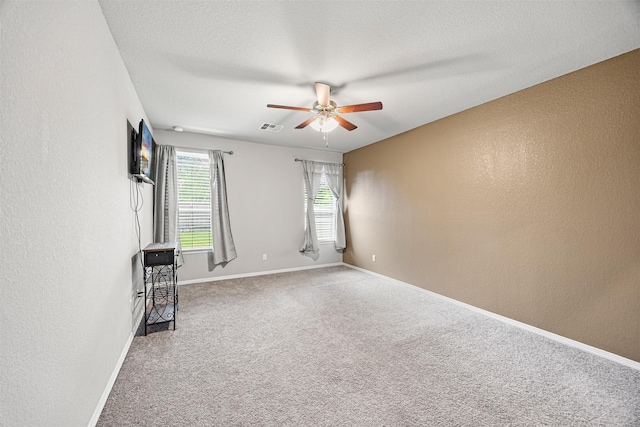 24818 Russet Bluff Trl, Houston, TX 77336 - spare room with carpet floors, baseboards, visible vents, ceiling fan, and a textured wall