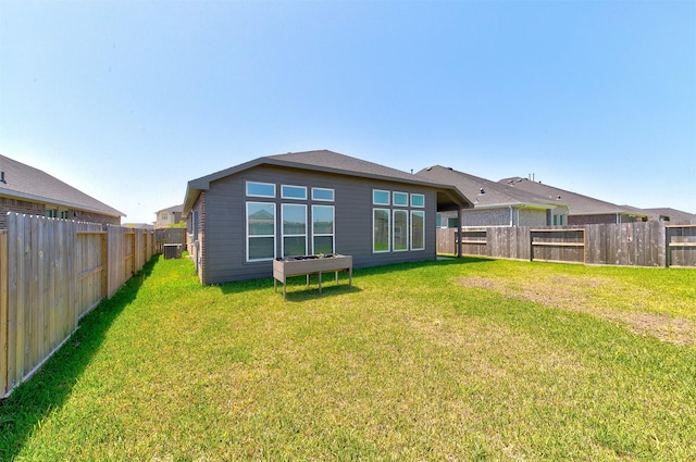 12006 Wooden Mill Ln, Santa Fe, TX 77510 - back of property featuring cooling unit, a fenced backyard, and a lawn