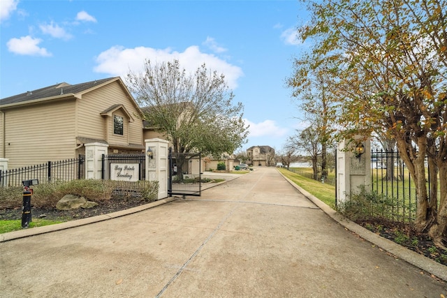 356 Old Aqua Lndg W, Conroe, TX 77356 - view of road featuring a gate and curbs