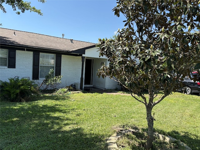 431 Crockett St, Channelview, TX 77530 - ranch-style house with roof with shingles, brick siding, and a front lawn