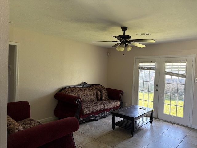 431 Crockett St, Channelview, TX 77530 - living room featuring baseboards, light tile patterned floors, a textured ceiling, visible vents, and ceiling fan
