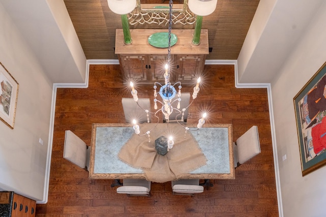 dining room with wooden ceiling, wood finished floors, and wooden walls