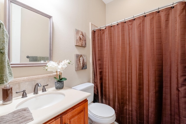 full bathroom featuring toilet and vanity