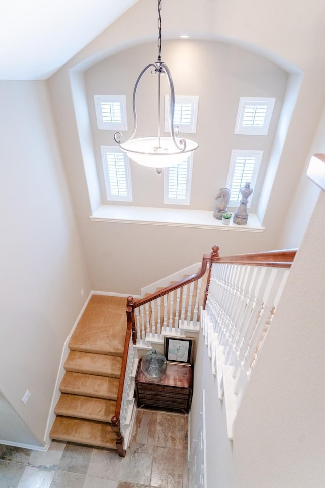 staircase with healthy amount of natural light and baseboards
