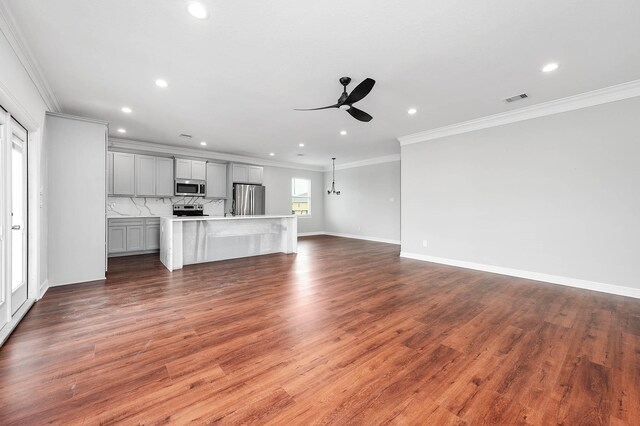 4014 Mitote Dr, Galveston, TX 77554 - unfurnished living room featuring a ceiling fan, recessed lighting, ornamental molding, and dark wood-style floors