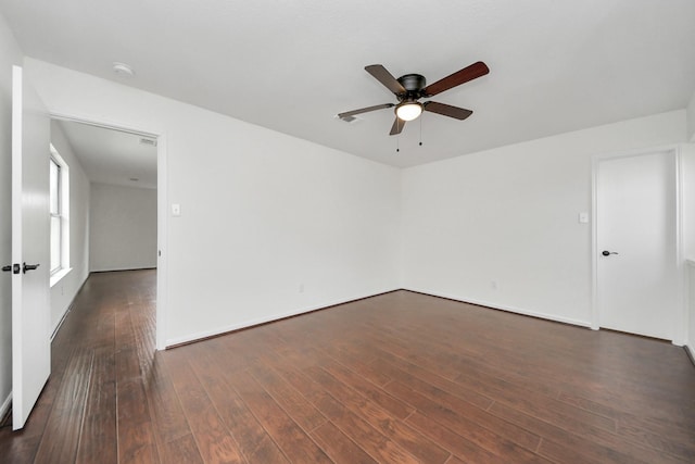 spare room featuring a ceiling fan and dark wood finished floors