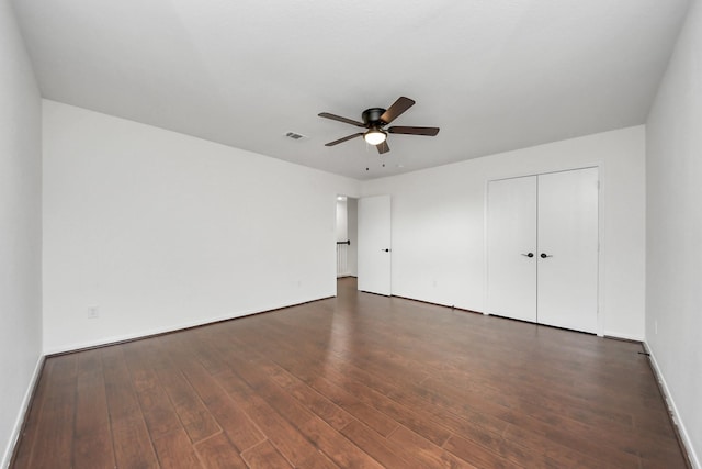 interior space with a closet, dark wood-style flooring, baseboards, and a ceiling fan