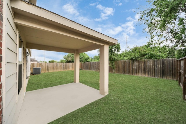 view of yard featuring central AC unit, a fenced backyard, and a patio area