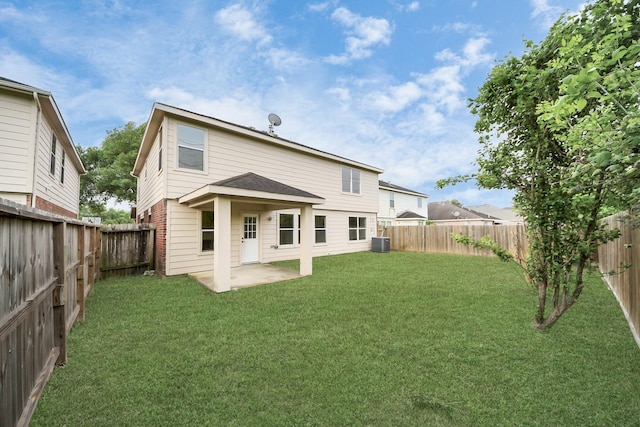 back of house with a lawn, central AC unit, a fenced backyard, and a patio