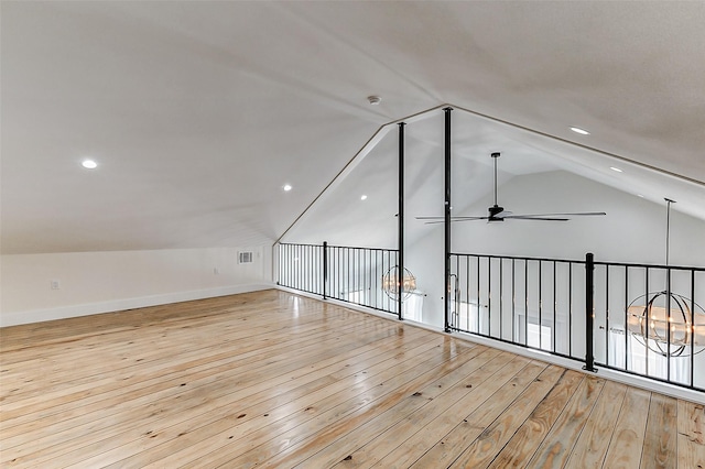 additional living space featuring visible vents, baseboards, a ceiling fan, lofted ceiling, and light wood-style floors