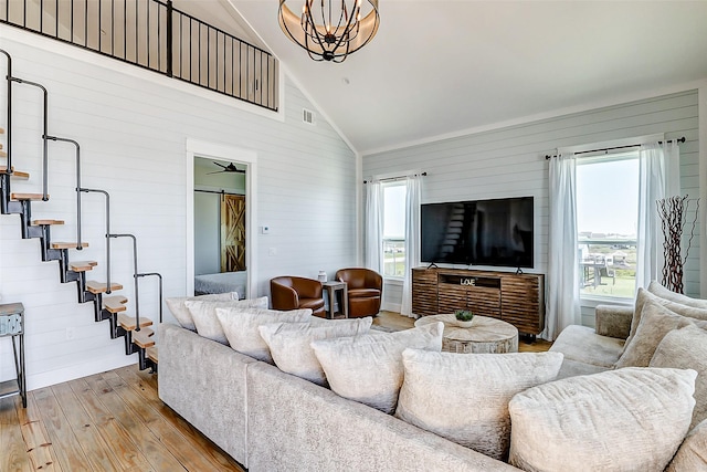 living room featuring high vaulted ceiling, visible vents, and hardwood / wood-style flooring