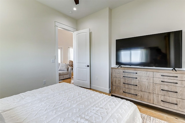 bedroom featuring baseboards, light wood finished floors, and recessed lighting
