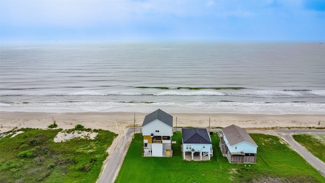 drone / aerial view featuring a water view and a beach view