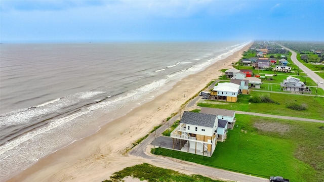 drone / aerial view featuring a water view and a beach view