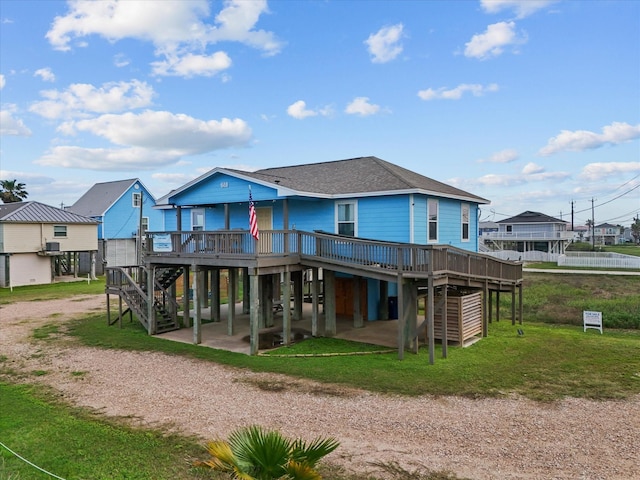 818 Surf Dr, Surfside Beach, TX 77541 - rear view of house with stairway, a wooden deck, dirt driveway, and a carport