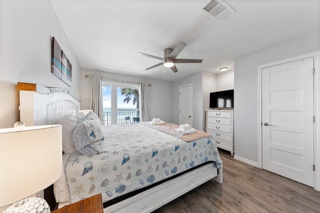 7600 Seawall Blvd Unit 214, Galveston, TX 77551 - bedroom with wood finished floors, access to outside, and a ceiling fan
