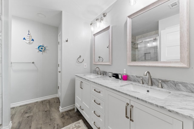 7600 Seawall Blvd Unit 214, Galveston, TX 77551 - full bath with double vanity, wood finished floors, and a shower stall