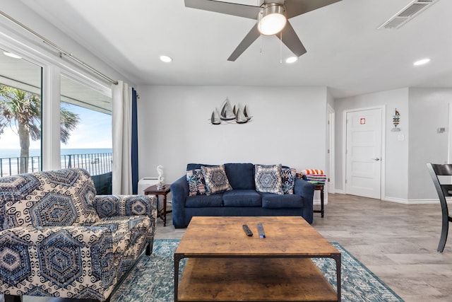 7600 Seawall Blvd Unit 214, Galveston, TX 77551 - living area featuring light wood-style floors, a water view, recessed lighting, and a ceiling fan
