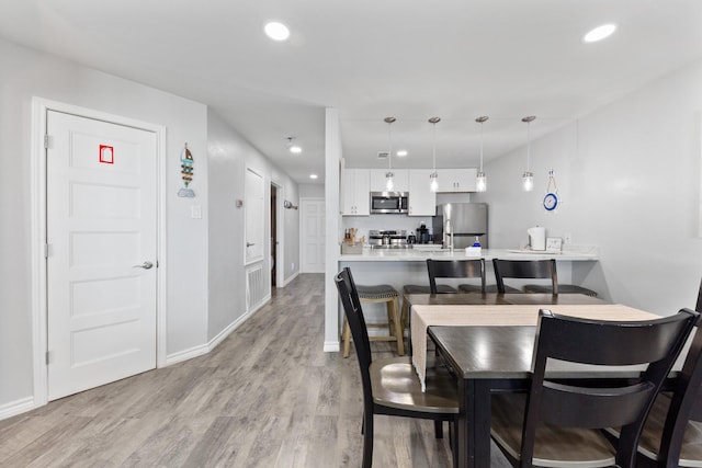 7600 Seawall Blvd Unit 214, Galveston, TX 77551 - dining room featuring recessed lighting and light wood-type flooring