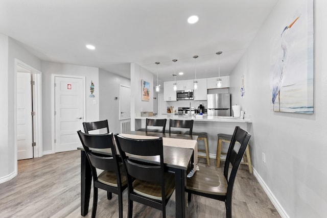 7600 Seawall Blvd Unit 214, Galveston, TX 77551 - dining space featuring light wood-style floors and recessed lighting