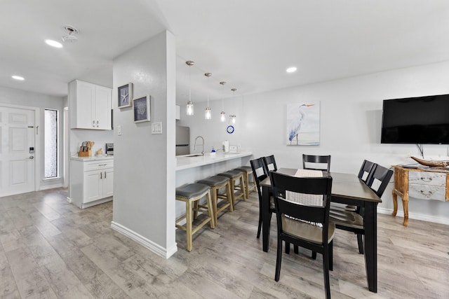 7600 Seawall Blvd Unit 214, Galveston, TX 77551 - dining room featuring light wood finished floors and recessed lighting
