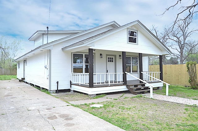 bungalow-style house featuring a porch and fence