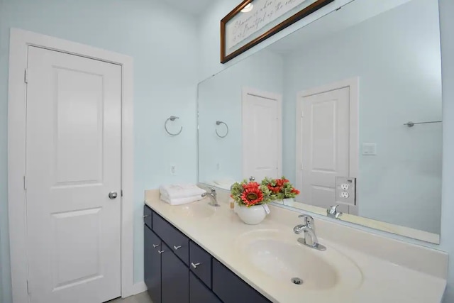 full bathroom featuring double vanity and a sink
