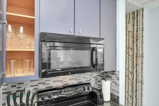 room details with black microwave and tasteful backsplash