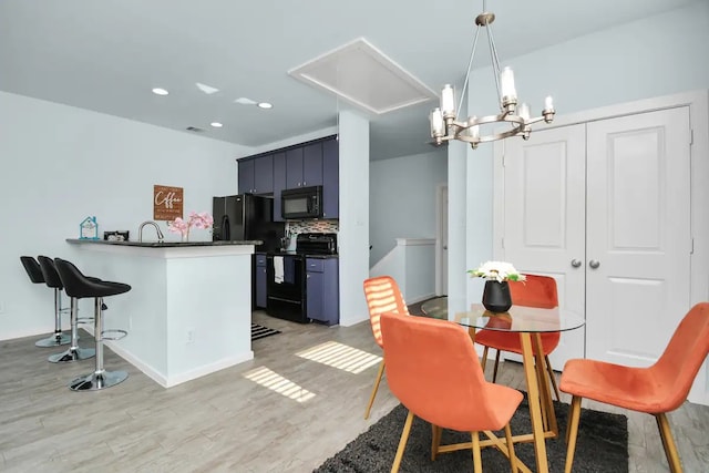 dining space with recessed lighting, attic access, light wood-type flooring, visible vents, and a notable chandelier
