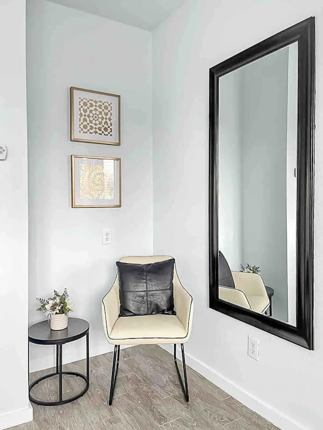sitting room with wood finished floors and baseboards