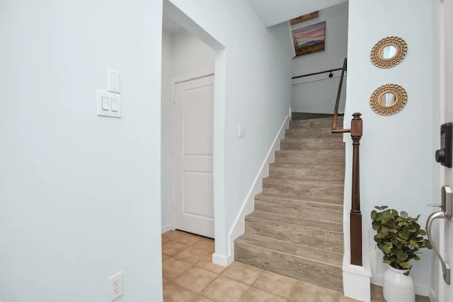 stairs with tile patterned flooring