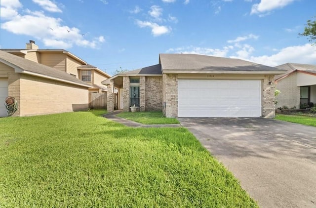 13523 Bonilla Ln, Houston, TX 77083 - view of front facade with a front lawn, an attached garage, driveway, and brick siding
