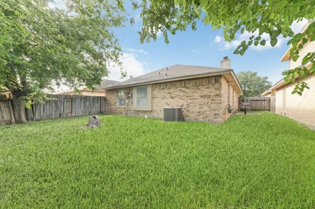 13523 Bonilla Ln, Houston, TX 77083 - rear view of property with a chimney, cooling unit, and brick siding
