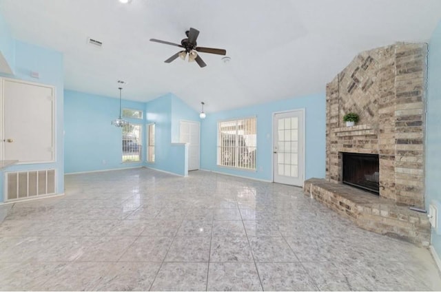 13523 Bonilla Ln, Houston, TX 77083 - unfurnished living room featuring vaulted ceiling, a brick fireplace, a ceiling fan, baseboards, and a chandelier