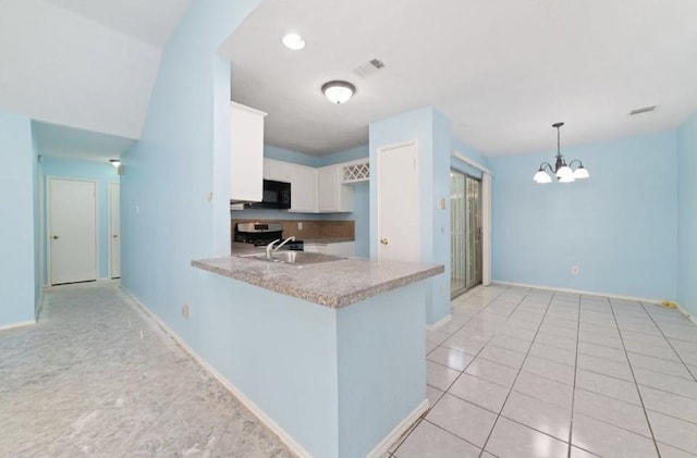 13523 Bonilla Ln, Houston, TX 77083 - kitchen with black microwave, range, white cabinetry, light countertops, and a peninsula