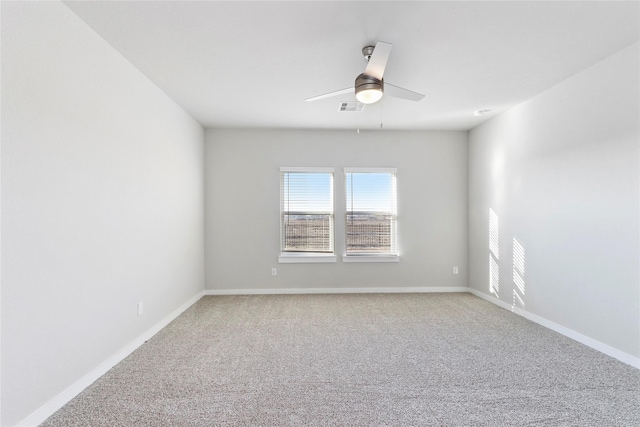 unfurnished room with a ceiling fan, baseboards, light colored carpet, and visible vents
