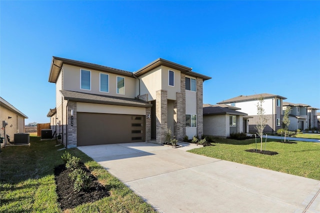 prairie-style house featuring cooling unit, stucco siding, an attached garage, driveway, and a front yard