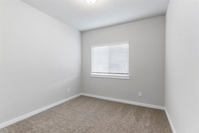spare room with carpet floors and baseboards
